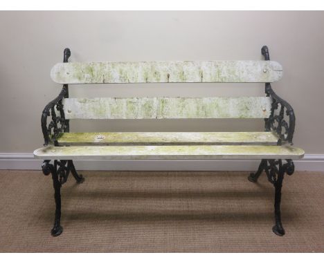 A Garden Bench with black painted cast iron Coalbrookdale style supports and white painted slats, 4ft 3in W