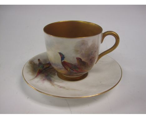 A Royal Worcester Cup and Saucer painted pheasants in landscape, signed Jas Stinton