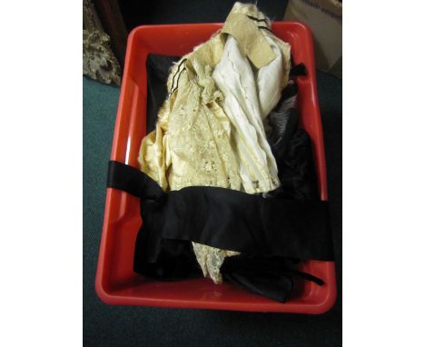 A large box of Victorian Costume including a sash with beaded buckle, black dresses, skirts and underskirts, etc