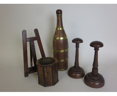 Pair of turned oak Wig Stands, 8in H, an olivewood octagonal Pen Stand, 4in H x 4in D, a mahogany desk top Easel, 10in H and 