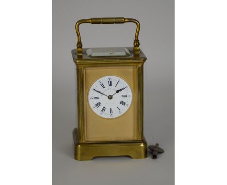 A brass Carriage Clock by the Goldsmiths & Silversmiths Co, with circular enamel dial marked with Roman Numerals