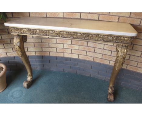 A 19th Century gilt Console Table with white marble top having rounded corners, frieze with leafage, shell and egg and dart d