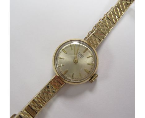 A Lady’s 9ct gold Tudor Wristwatch, on integral Rolex bracelet, champagne dial, with baton markers, case width 18mm