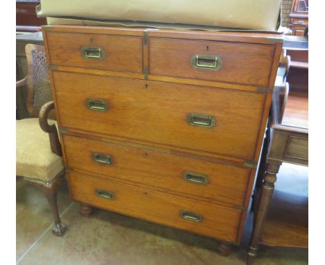 An early 19th Century brass mounted Military Campaign Chest of two short and three long drawers in two parts having inset han