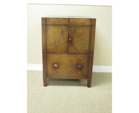 A Victorian mahogany Washstand Commode with double hinged top above a pair of doors on square tapering supports