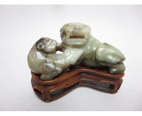 A mutton fat type jade Figure of a kylin, 3in, on hardwood stand 