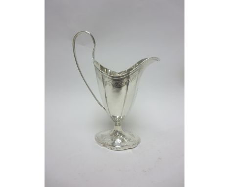 A George III Scottish silver helmet shape Cream Jug with engraved cartouche and later floral embossed pedestal base, Edinburg