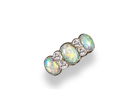 An opal and diamond ring, set with three oval~shaped cabochon opals and four circular~cut diamonds in platinum and gold. Size