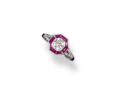 An Art Deco style ruby and diamond cluster ring, the round brilliant cut diamond is set within an octagonal surround of taper