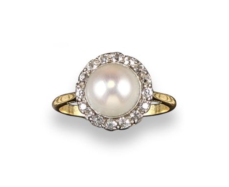 A natural freshwater pearl and diamond ring, the button~shaped pearl measured 10.80 diameter and is set within a surround of 