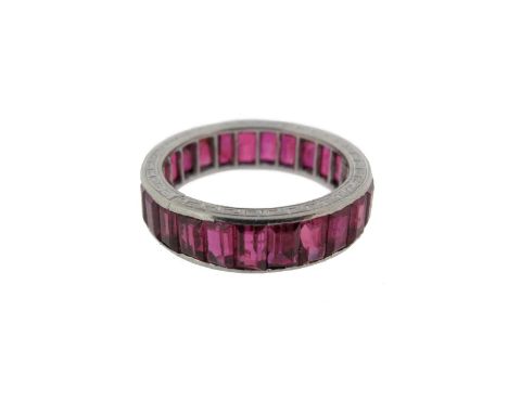 A ruby full circle eternity ring, the baguette~shaped rubies are channel set in platinum. Size L 1/2.