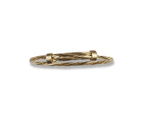 A gold bangle by Tiffany & Co, of flexible twisted rope design. Marked for Tiffany. 23g.
