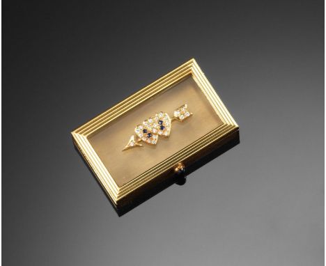 A small rectangular 18ct gold box by Asprey, the cabochon sapphire thumbpiece releases the spring~loaded hinged rock crystal 