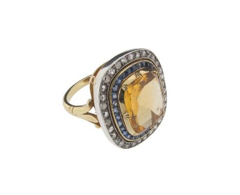 A citrine sapphire and diamond ring, the citrine is set with a calibre~cut sapphire surround and a further surround of rose~c