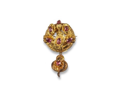 A Victorian gold brooch pendant, of foliate form with scroll engraved decoration and mounted with foil backed pink stones. Fi