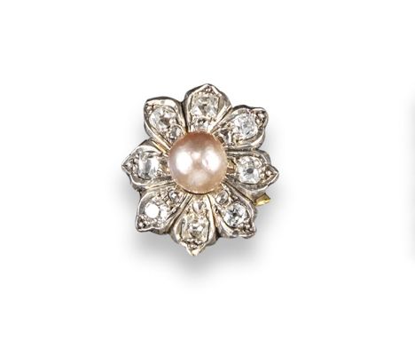 A natural pearl and diamond flower head ring, the pink pearl set within a surround of cushion shaped diamond petals in platin