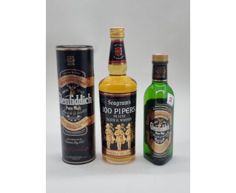 An old bottle of Seagram's '100 Pipers' Deluxe Scotch Whisky, 1970s bottling; together with a 35cl bottle of Glenfiddich 'Pur