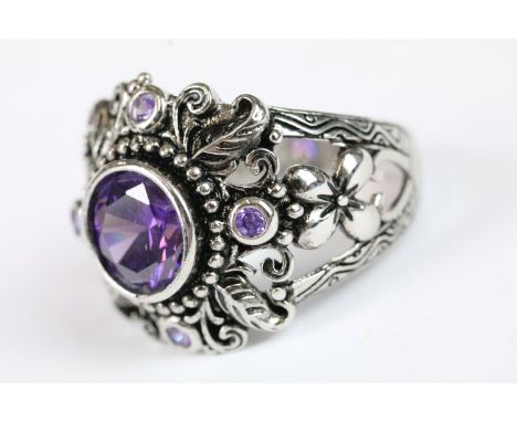 A ladies silver dress ring with central amethyst, marked 925 to the shank.