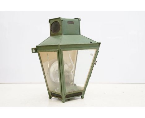 19th Century wall mounted oil lantern having a painted metal exterior with glass panels to sides and oil burner with flu with