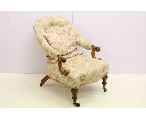 Victorian mahogany carved open armchair, with carved scrolling arms and upholstered button back on turned legs and castors, 7