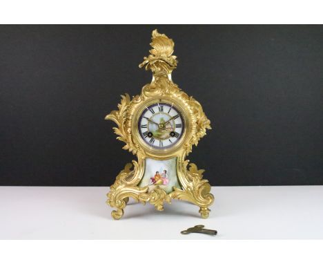 French gilt mantle clock with hand painted porcelain plaque below clock face, Roman numerals on a round hand painted dial wit