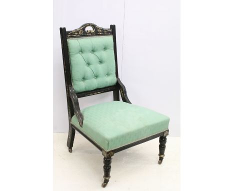 Edwardian ebonised low chair with gilded decoration, green upholstered button back above upholstered seat on turned legs and 
