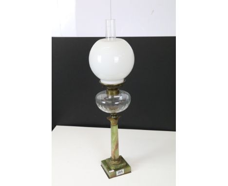 Early 20th Century onyx oil lamp with clear faceted reservoir and milk glass globular shade. Measures 70cm tall.