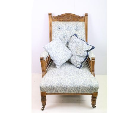 William Morris pattern upholstered button back, carved oak chair with castor feet together with two cushions H99cm, W 64cm, D