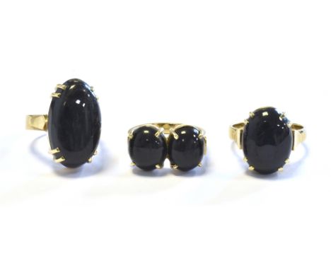 THREE 9CT GOLD RINGS  claw set with oval cabochon blue onyx, in heavy 9ct gold mounts, all stamped 375.  Ring sizes P and R. 