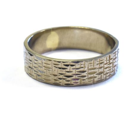 18CT WHITE GOLD BAND 5.3mm wide, with textured decoration, ring size O.  Hallmarked 18 London 1972.  Weight 4.9 grams.