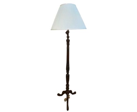 Carved mahogany tripod standard lamp on claw feet.