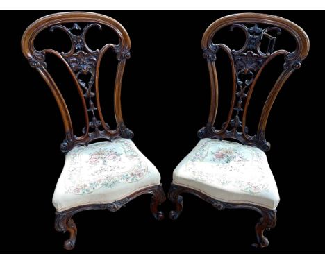 Pair Victorian mahogany open spoon back nursing chairs with floral tapestry seats.