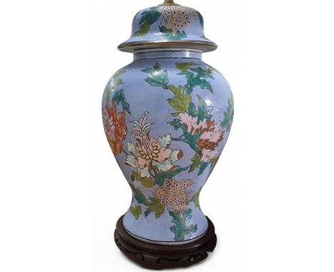 A ceramic 'ginger jar' lamp base, decorated stylised flowers and foliage on a lavender ground, padouk wood stand, approx. 48c
