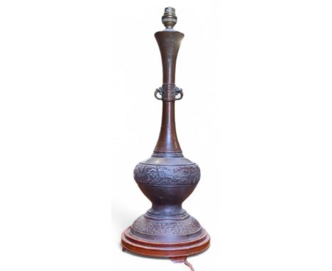 An early 20th century archaistic patinated bronze table lamp on plinth base, 54.5cm high