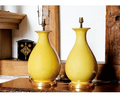 A PAIR OF YELLOW GLAZED BOTTLE VASE, LAMP YUHUCHUN. 19TH CENTURY Well-potted, the gently rounded sides rising from a spreadin