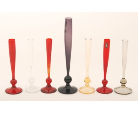 A group of seven post war Whitefriars bud vases, all of tapering form above a knop and circular domed foot, with examples in 