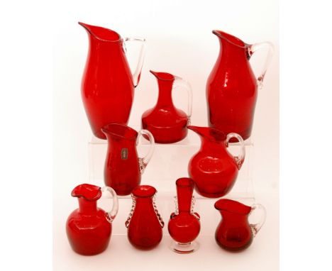 A group of later 20th Century Whitefriars glass jugs and vases, all in ruby, a variety of sizes and patterns including 9620, 