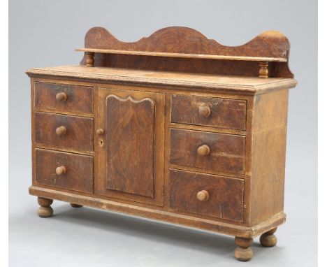 A VICTORIAN GRAIN-PAINTED PINE DRESSER, the moulded rectangular top with galleried shelf back, over a panelled cupboard door 