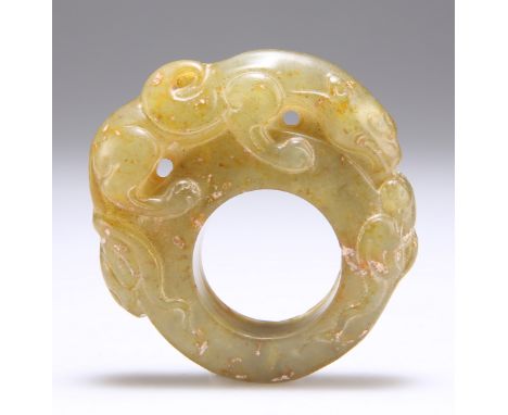 A CHINESE CARVED HARDSTONE RING OR TOGGLE, surmounted by a tiger and scrolls. Measures 6cm by 5cmThe absence of a Condition R
