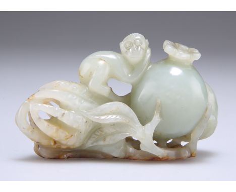 A CHINESE JADE CARVING, depicting a monkey climbing upon fruits, the stone of a pale colour with russet markings. 7.5cm wide