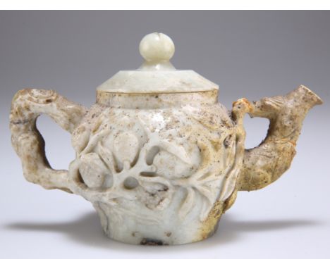 A 19TH CENTURY CHINESE JADE TEAPOT AND COVER, carved with fruiting vine. 9cm highThe absence of a Condition Report does not i
