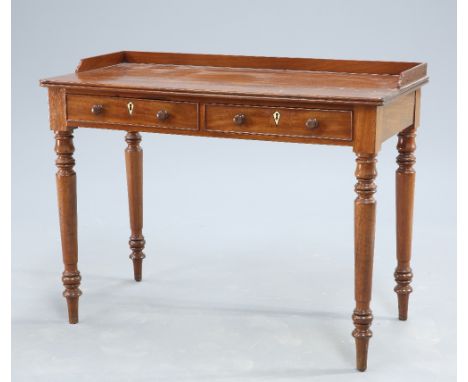 A VICTORIAN MAHOGANY WRITING DESK, the galleried top above a moulded edge over a pair of frieze drawers with turned pulls, ra