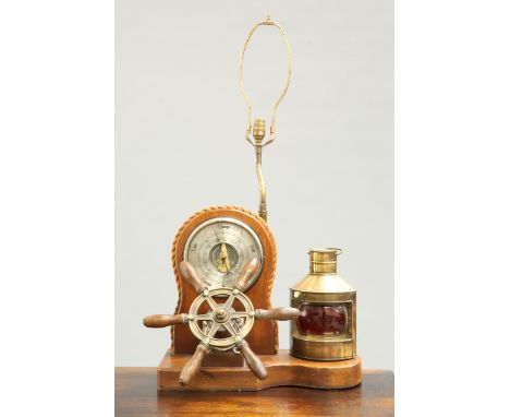 A BRASS-MOUNTED LAMP AND BAROMETER SET OF NAUTICAL INTEREST, mounted with a ships wheel, barometer and lamp. 69cm high to top
