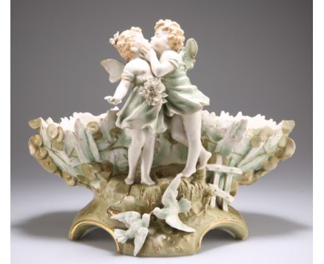 AN&nbsp;ERNST WAHLISS&nbsp;TURN VIENNA FIGURAL CENTREPIECE, CIRCA 1900, designed as a pair of kissing putti before an oval re