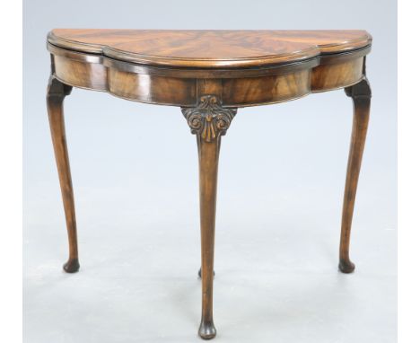 A CHIPPENDALE STYLE MAHOGANY FOLD OVER CARD TABLE, EARLY 20TH CENTURY, the lobed moulded top opening to reveal a green baize 