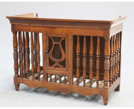 A 19TH CENTURY FRENCH FRUITWOOD PANETIERE, of characteristic openwork form with turned spindles and lyre-shaped panel to the 