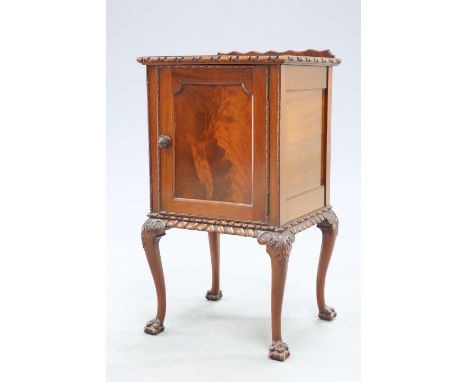A CHIPPENDALE STYLE MAHOGANY POT CUPBOARD, EARLY 20TH CENTURY, raised on leaf capped cabriole legs terminating in ball and cl