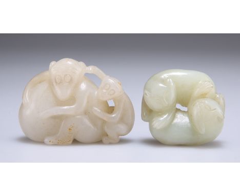 TWO CHINESE JADE CARVINGS, the first carved as two cats, the second as two monkeys with fruit. (2) Monkeys 5cm wideThe absenc