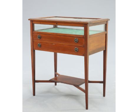 AN EDWARDIAN SATINWOOD BANDED MAHOGANY BIJOUTERIE TABLE, rectangular, the glazed case above two long drawers, raised on strin