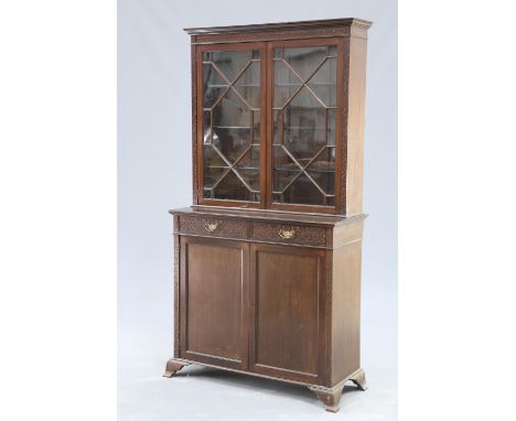 A VICTORIAN CHIPPENDALE REVIVAL MAHOGANY CABINET, the upper section with blind fretwork carved frieze and pilasters, surround